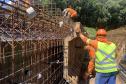 Pessoas trabalhando na obra de concretagem na duplicação em Guarapuava