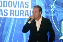 Homem falando no microfone em cima do palco