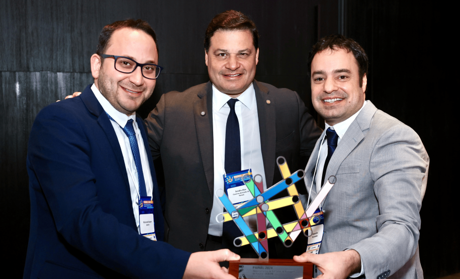 homens segurando Troféu PAINEL 2024