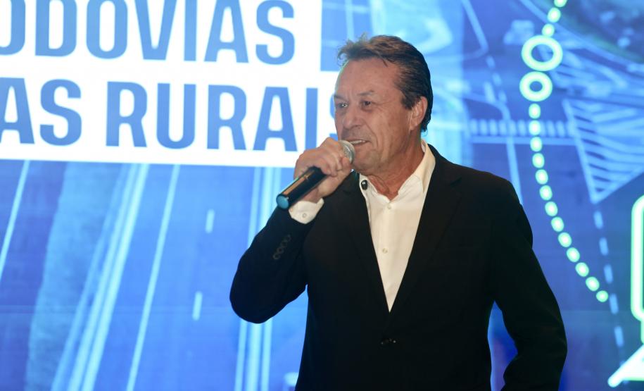 Homem falando no microfone em cima do palco